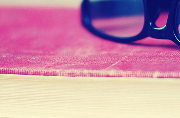 glasses laying on a book